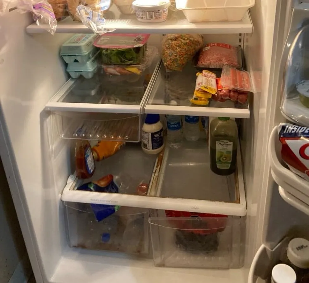 Refrigerator interior with glass shelves, drawers, and crispers